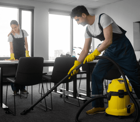 a man and woman cleaning a room