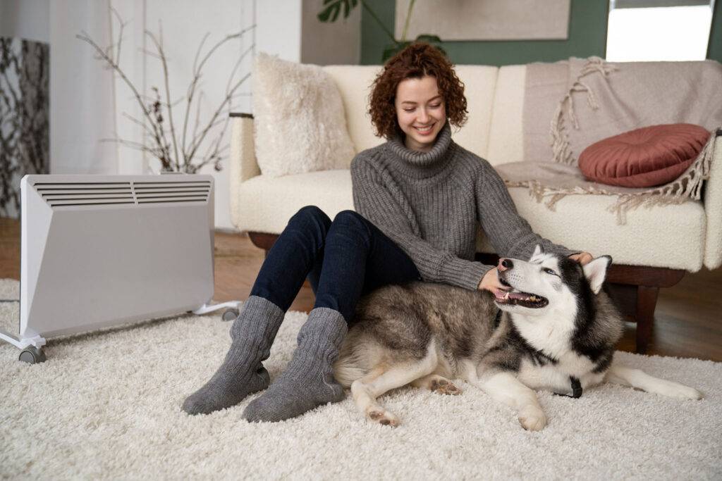 a pet owner with her husky relaxing on the carpet