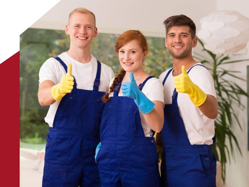 a group of people wearing blue overalls and yellow gloves