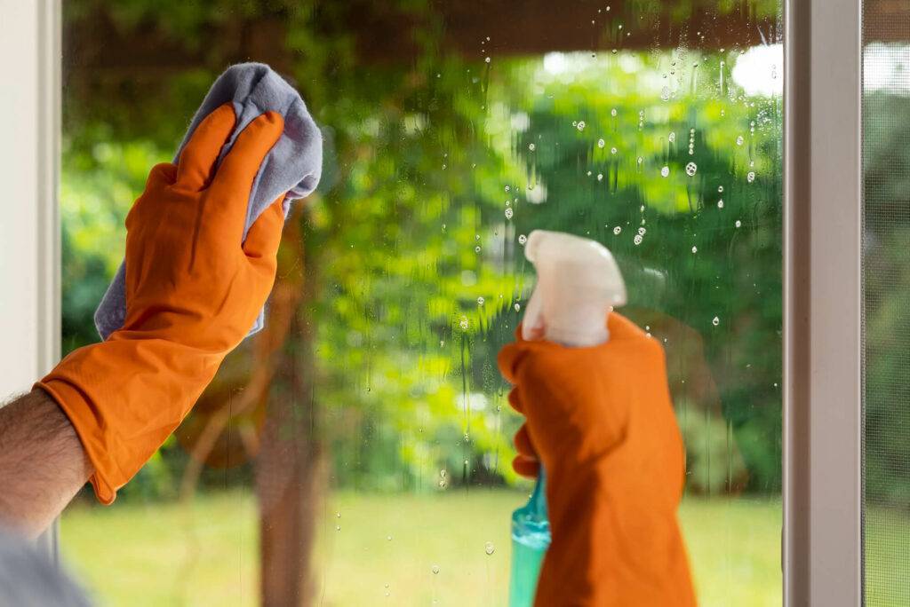 a person cleaning a window