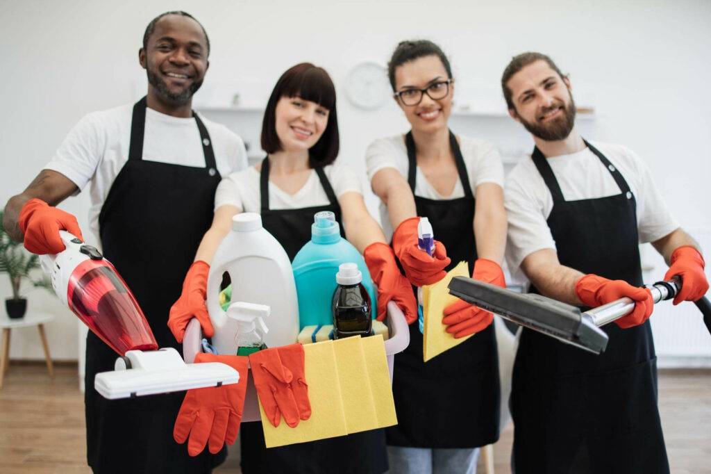 Cleaning team with supplies ready for housekeeping services.